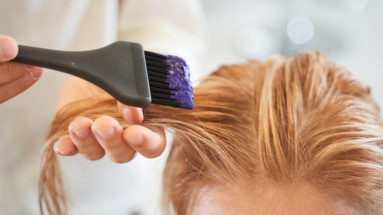 Woman getting hair dyed