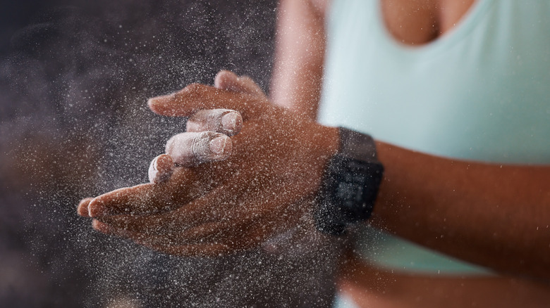 Woman rubbing talcum powder on her hands