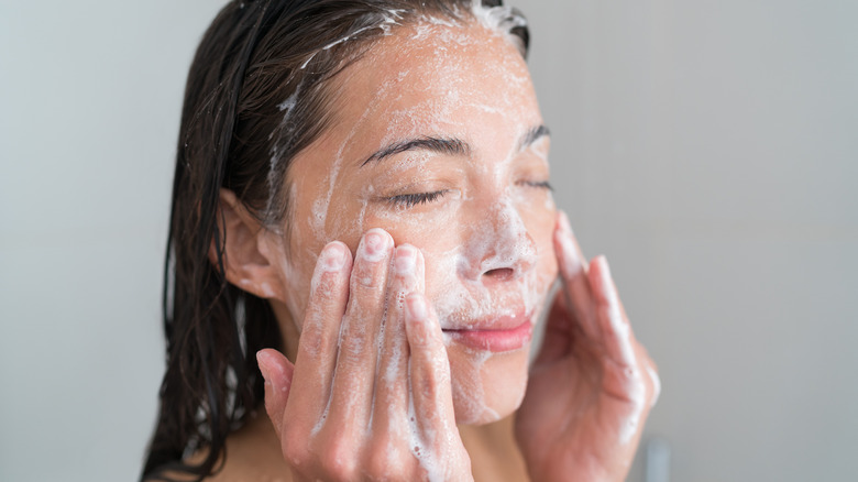 A woman cleansing her face