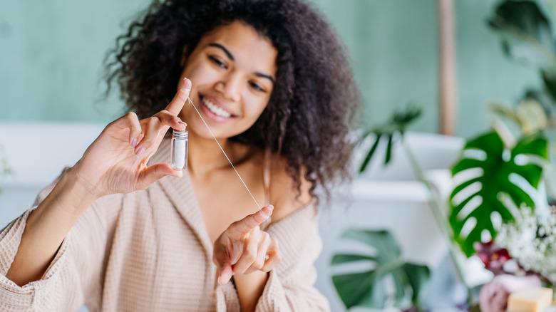 woman using sustainably packaged dental floss