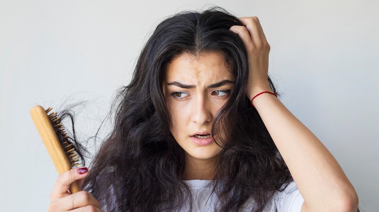 Woman with dry hair breaking off