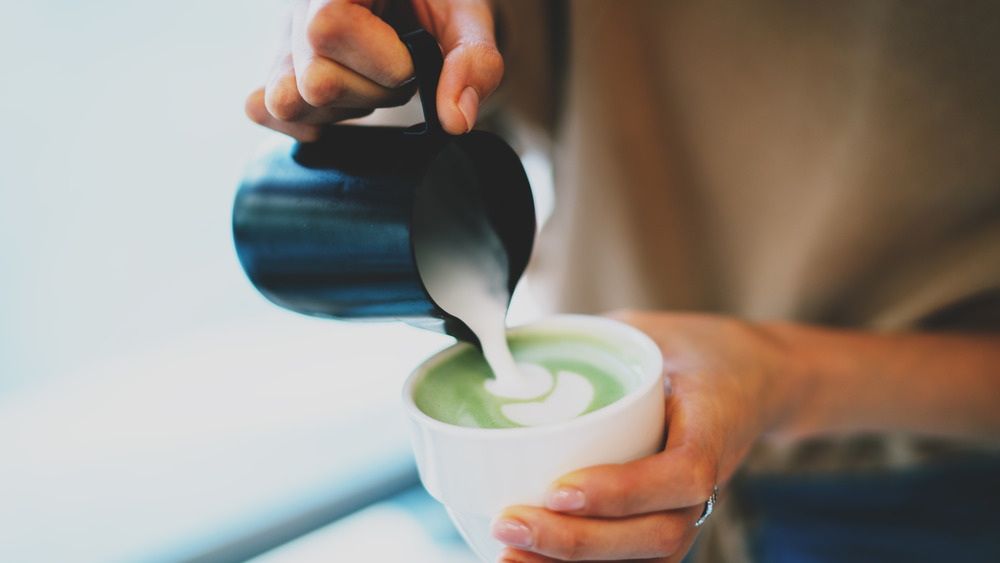 Pouring a matcha latte 