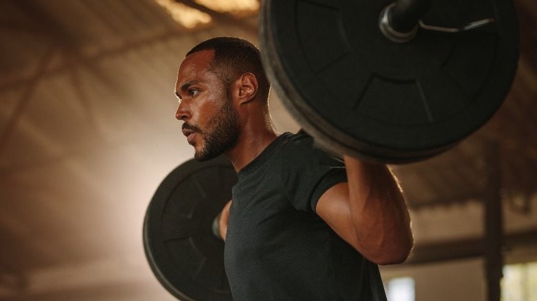 man lifting gym weights