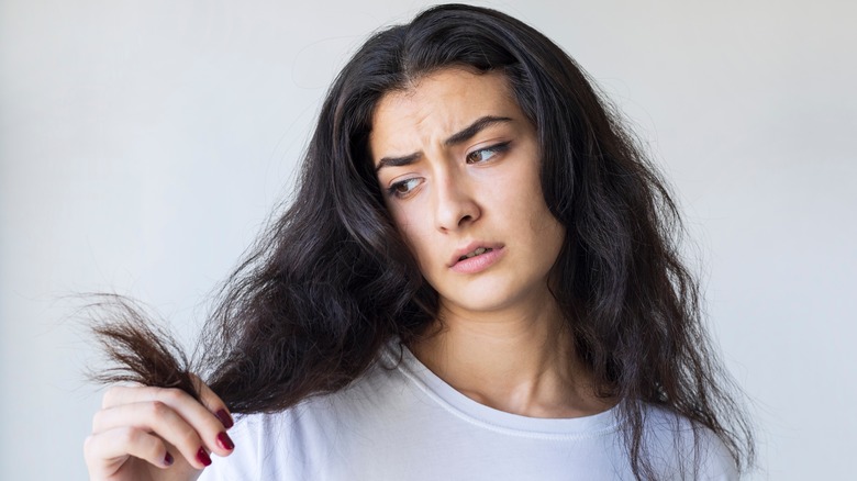 girl unhappy with damaged hair