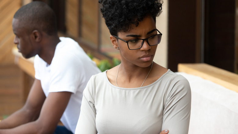 woman upset, facing away from man