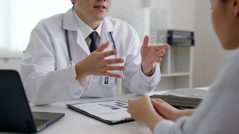 A dermatologist speaking to a patient