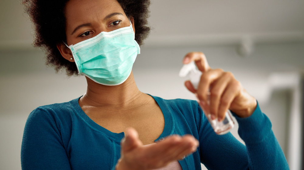 A woman pumping hand sanitizer