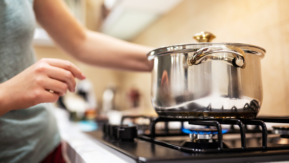 Woman preparing dinner on stove