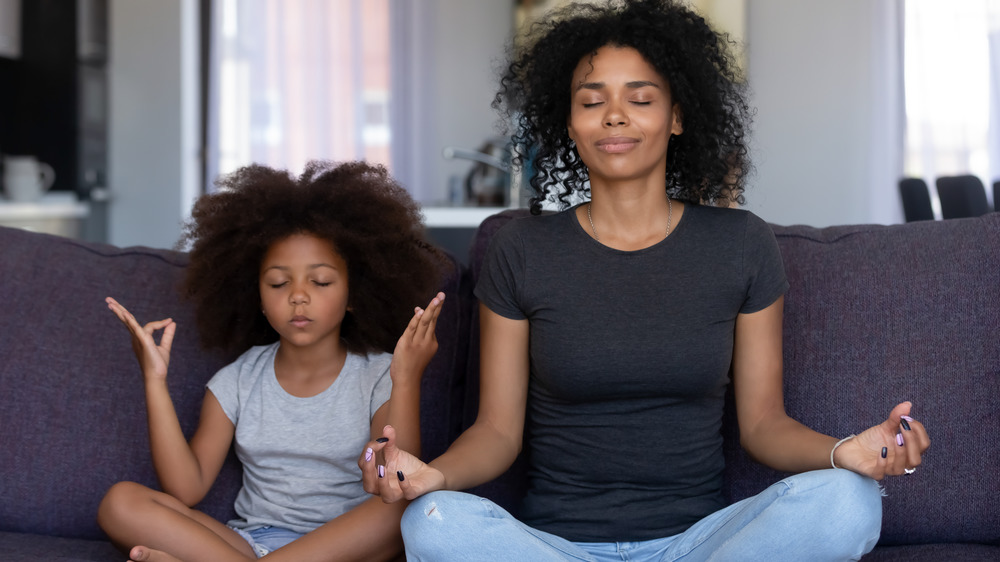 Mom and daughter meditating