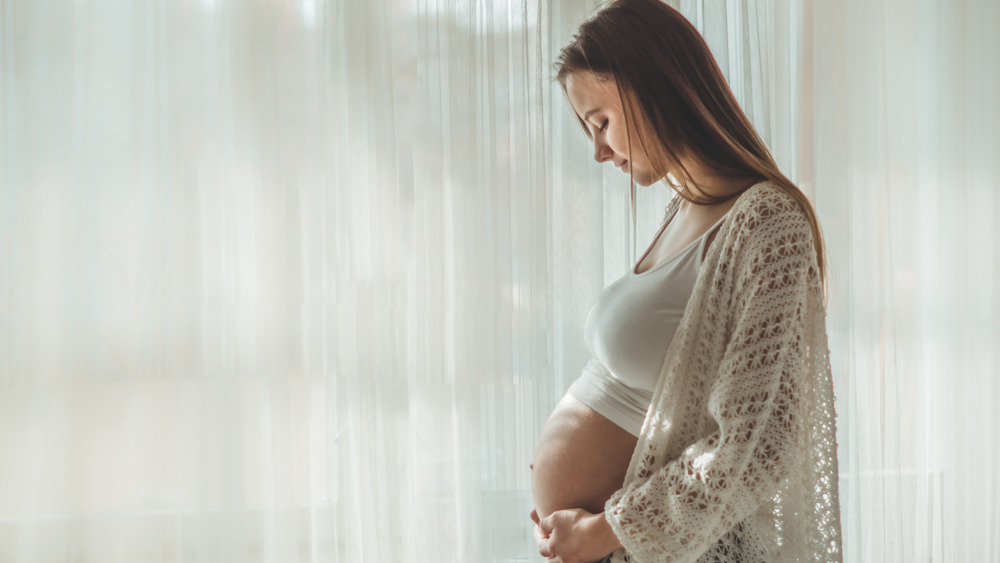 A woman holding her belly