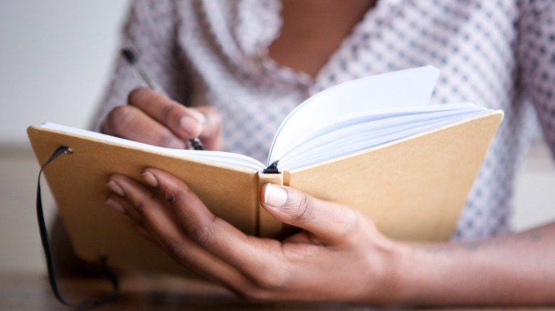 Woman writing in diary