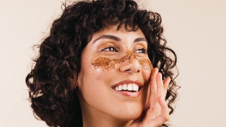 woman exfoliating her face