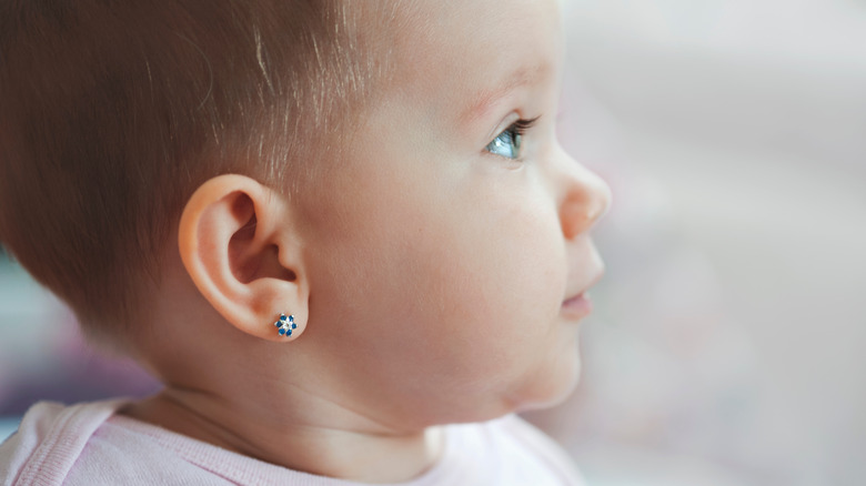 Baby in profile with earring in ear