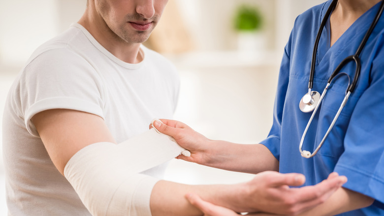 Doctor bandaging an arm