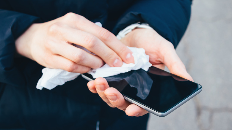 Person wiping smartphone screen