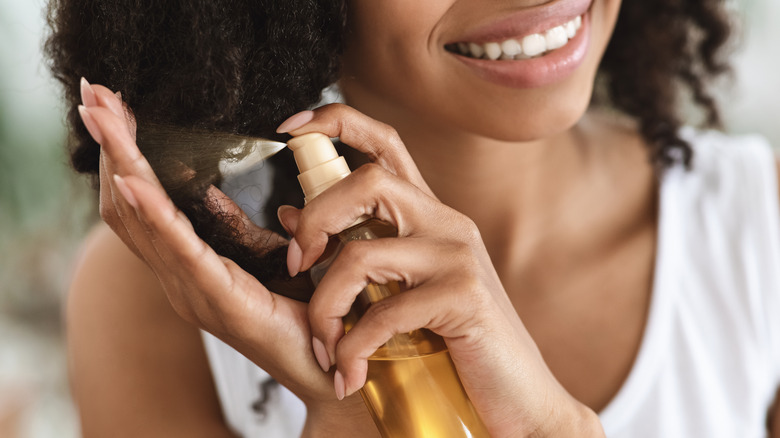 woman applying hair oil