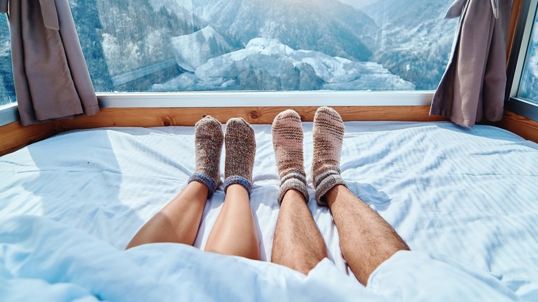 feet in bed near window