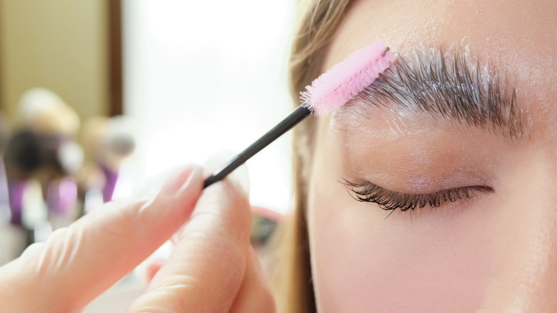 woman getting eyebrows permed