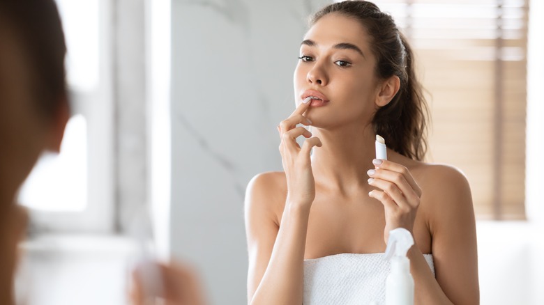 Woman applying lip balm 