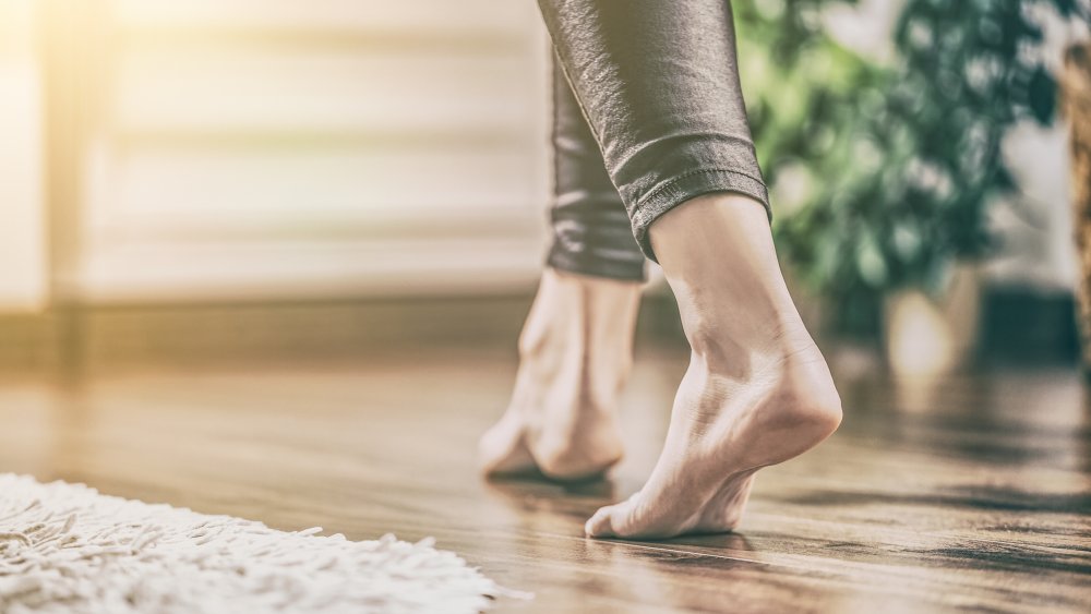 Woman in bare feet on a wooden floor