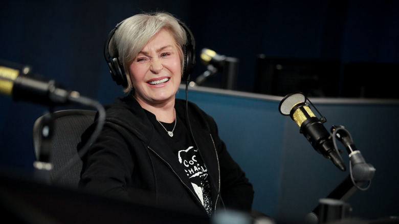 Sharon Osbourne laughing in front of microphone