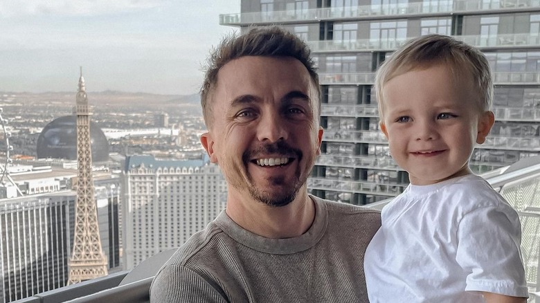 Frankie Muniz holding his son