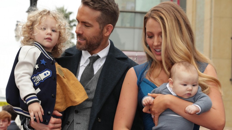 Ryan Reynolds and Blake Lively holding their kids