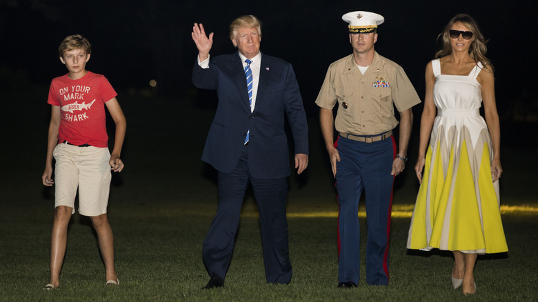 Barron Trump, Donald Trump, and Melania Trump walking