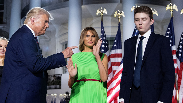 Donald Trump pointing at Barron Trump with Melania Trump