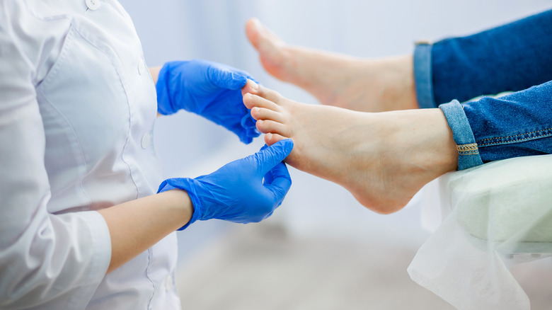 Doctor treating someone's toe pain