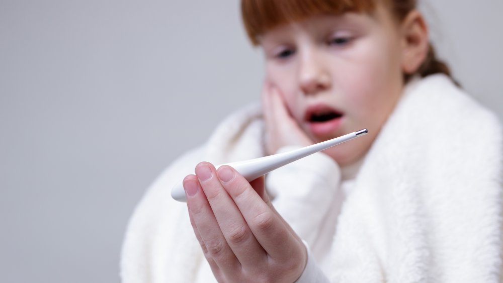 Girl looking at thermometer