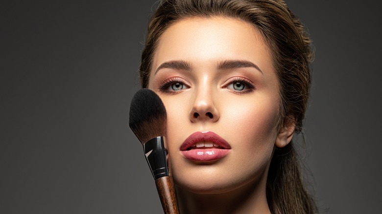 Woman holding makeup brush