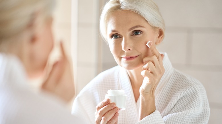 woman applying facial cream