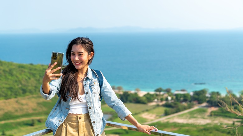 woman taking selfie by the beach