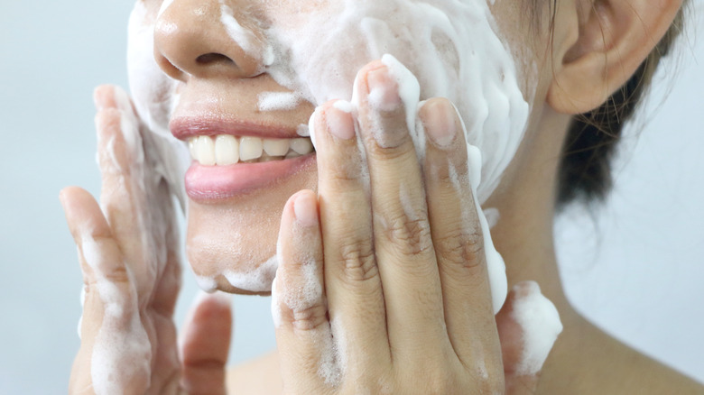 woman applying foaming cleanser