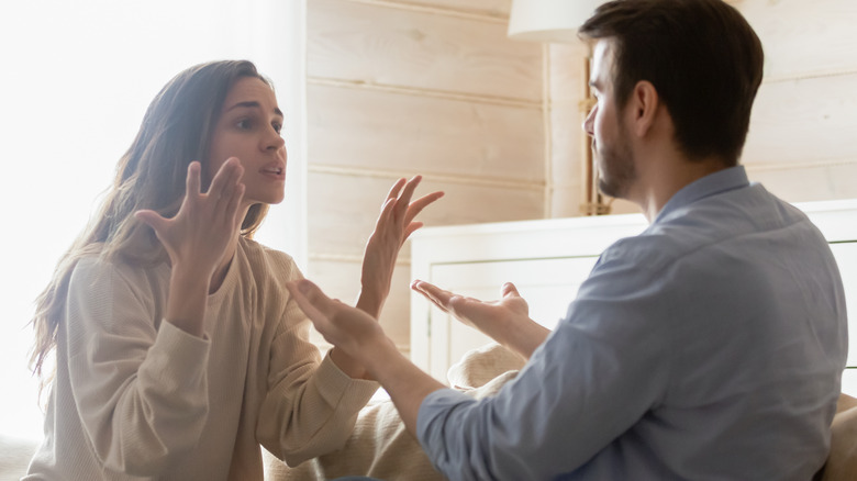 couple arguing on couch