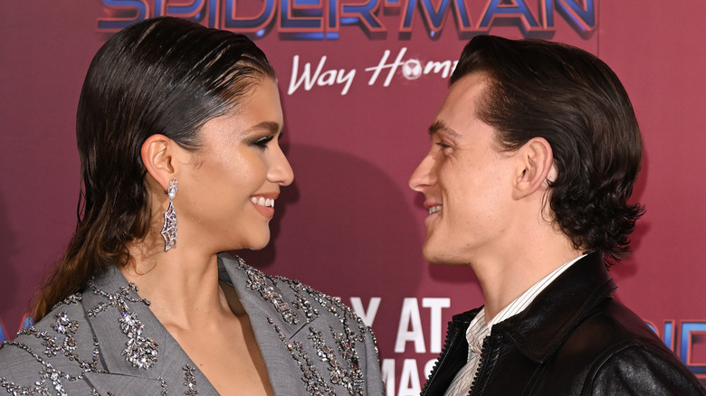 Tom Holland and Zendaya smiling at each other