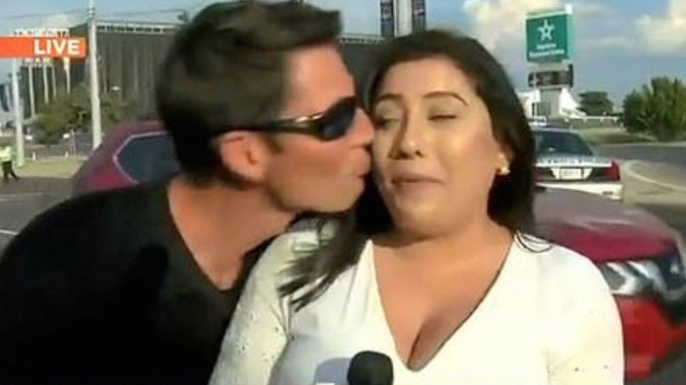 A man kissing a news anchor on the street on live TV