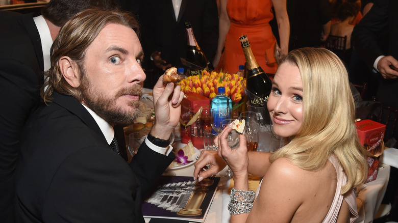 Dax Shepard and Kristen Bell holding up food