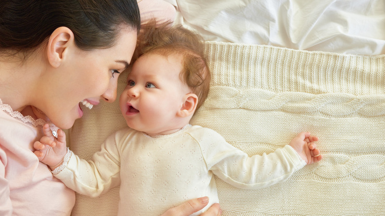 mom cuddling and smiling with baby