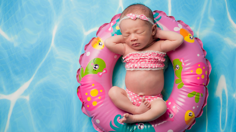 baby posing for picture in bathing suit swim scene