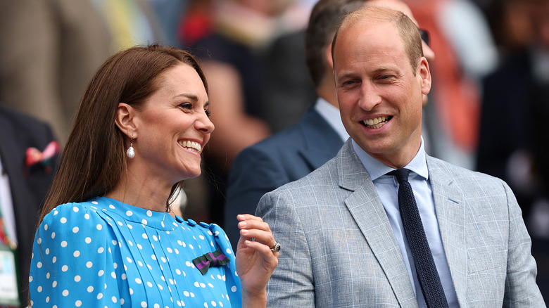 Prince William and Kate Middleton smiling in crowd