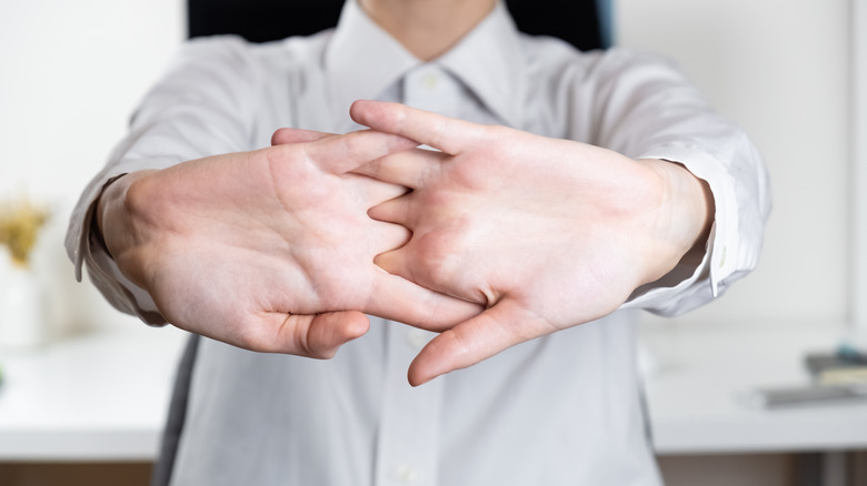 man cracking his knuckles