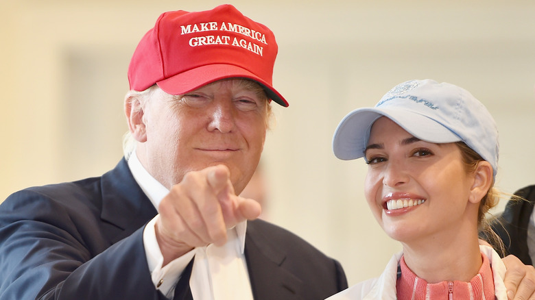 Donald Trump smiling with his hand on daughter Ivanka Trump's shoulder