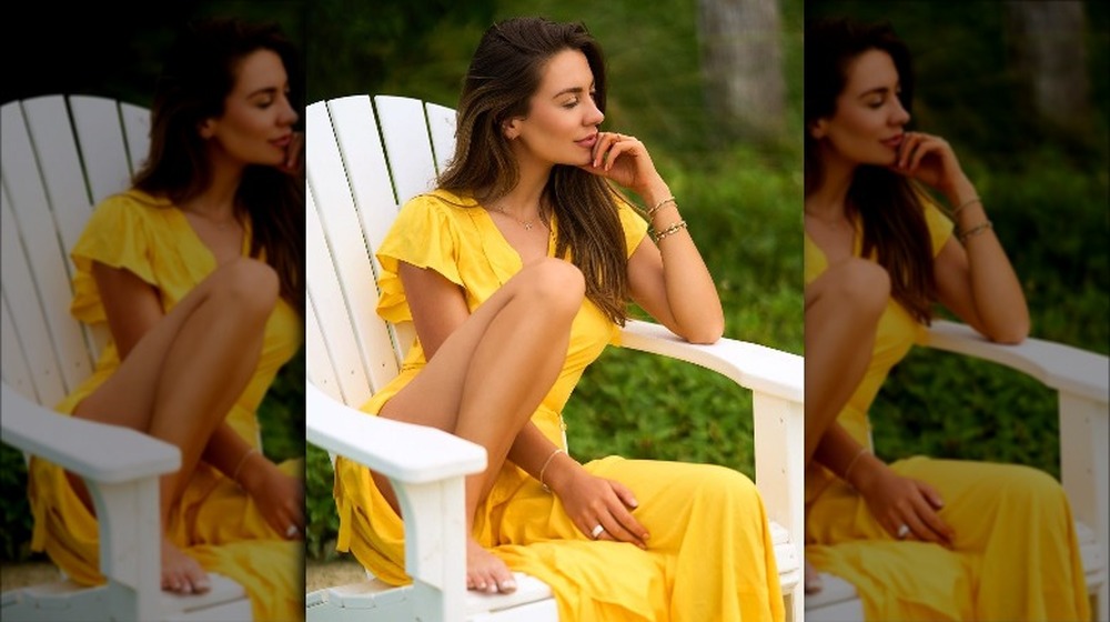 Kelley Flanagan sits wearing yellow