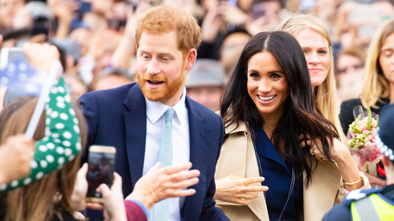 Prince Harry and Meghan Markle smiling at a royal event