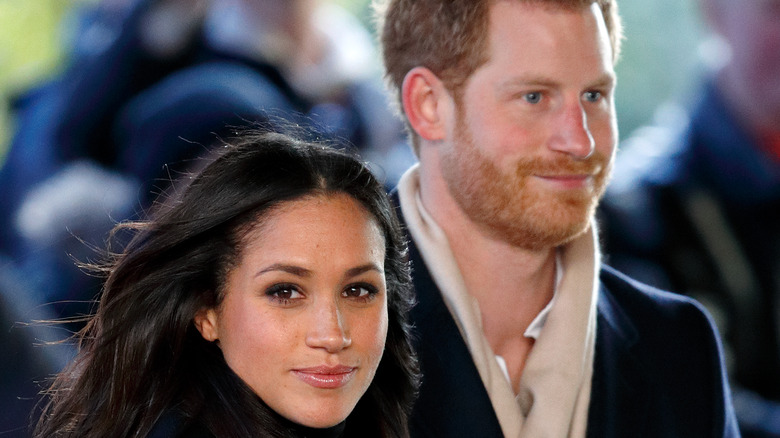 Prince Harry with wife Meghan Markle smiling