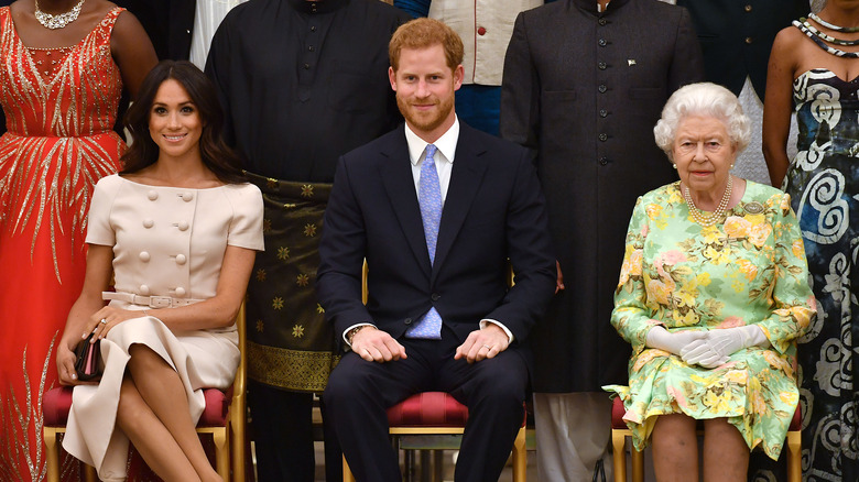 Meghan Markle, Prince Harry, Queen Elizabeth posing