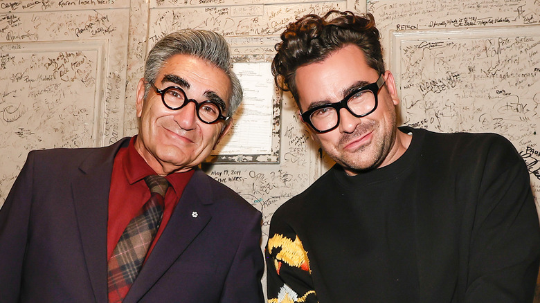 Eugene and Dan Levy pose together at an event