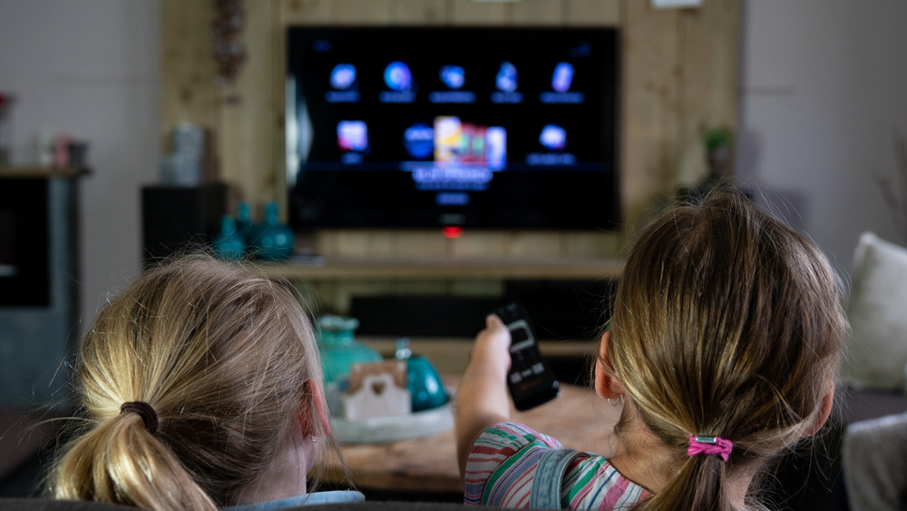 Two little girls watching TV